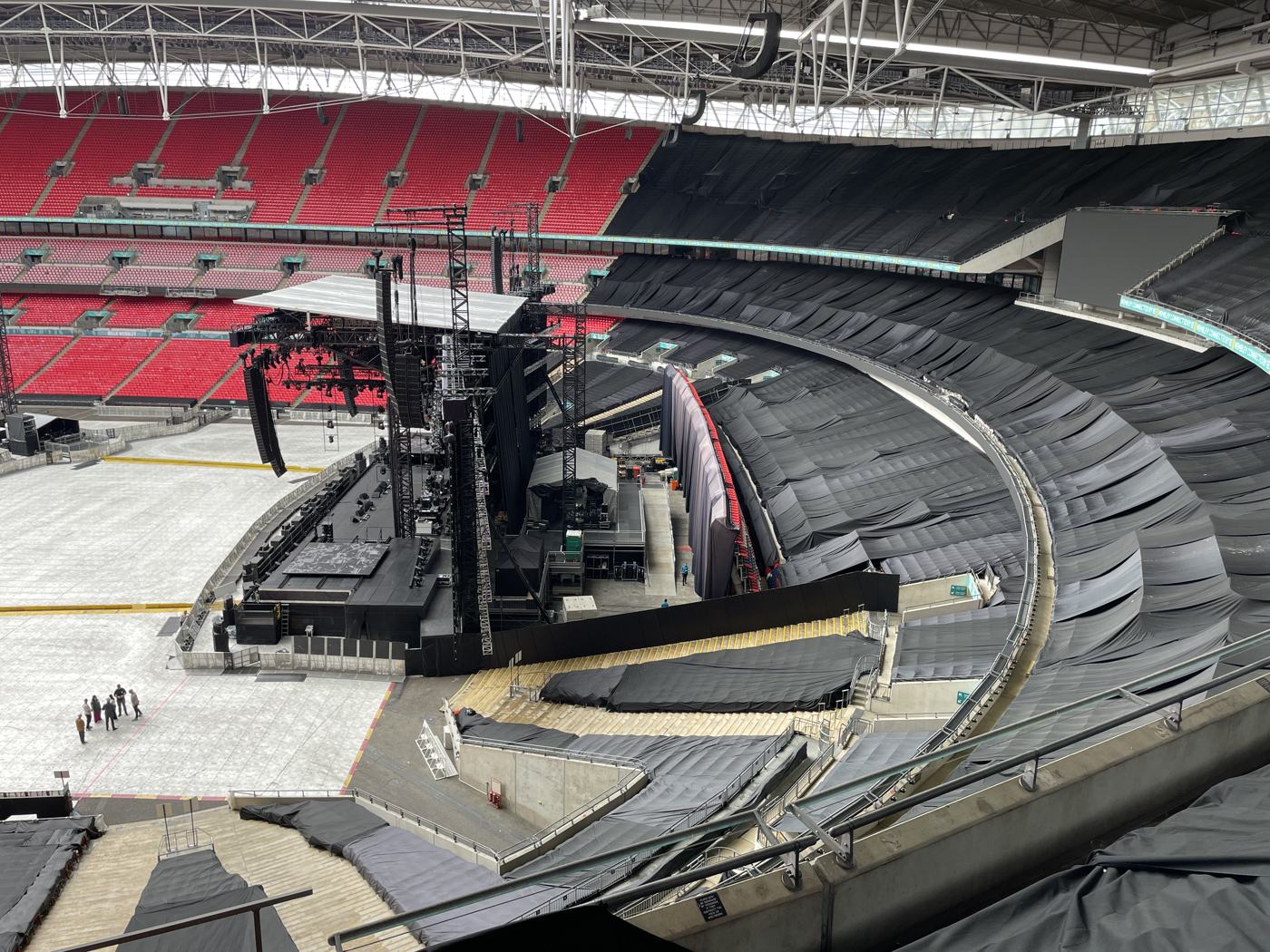Backstage and stage-side area with black drapes at Wembley