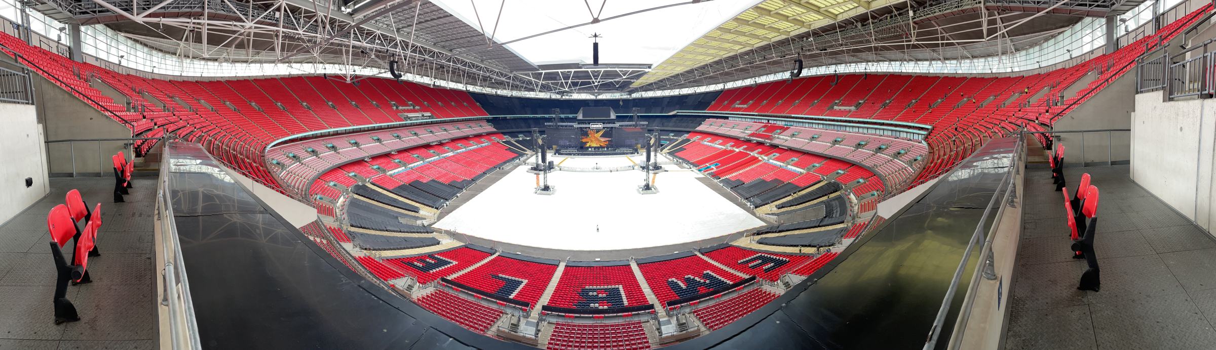 Panorama of Wembley Stadium from the upper tier, pitch covered and the Oasis stage built, July 2025